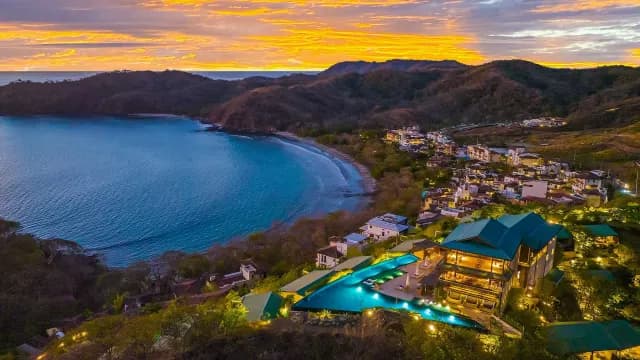 Aerial view of Casa Chameleon, overlooking the ocean during a sunset