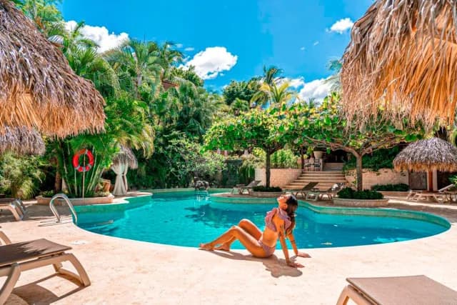 Woman sunbathing by the pool in Guanacaste