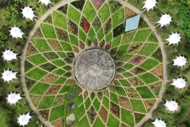Kinkara's tents seen from above, revealing a flowery pattern in the garden