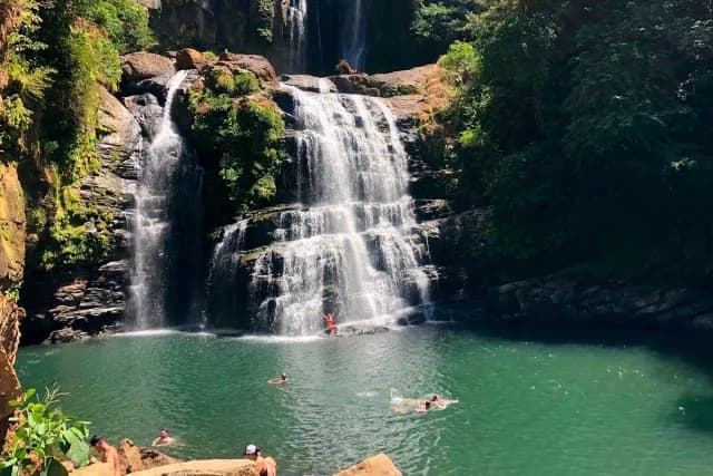 Visitors enjoying the natural pools at Nauyaca Waterfalls