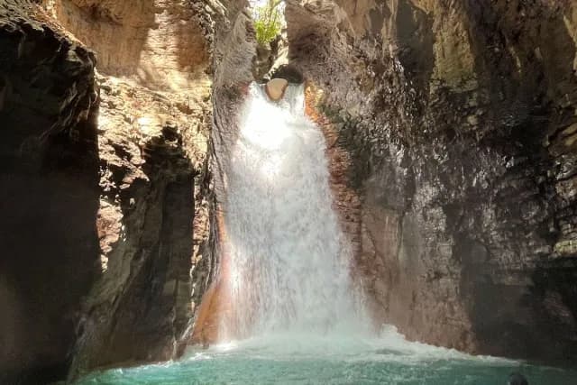 La Leona Waterfall with turquoise waters below