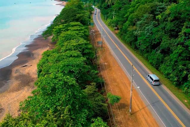 Aerial view of a Costa Rican road parallel to the ocean