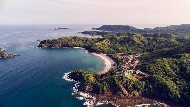 Aerial view of quiet afternoon in Las Catalinas, overlooking the ocean and surrounded by rainforests