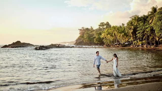 Couple walking down the beach for their wedding photos