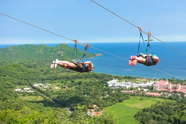 Two people ziplining at the Diamante Eco Adventure Park