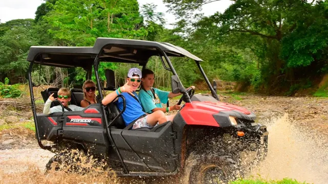 Family doing ATV tour in the mud